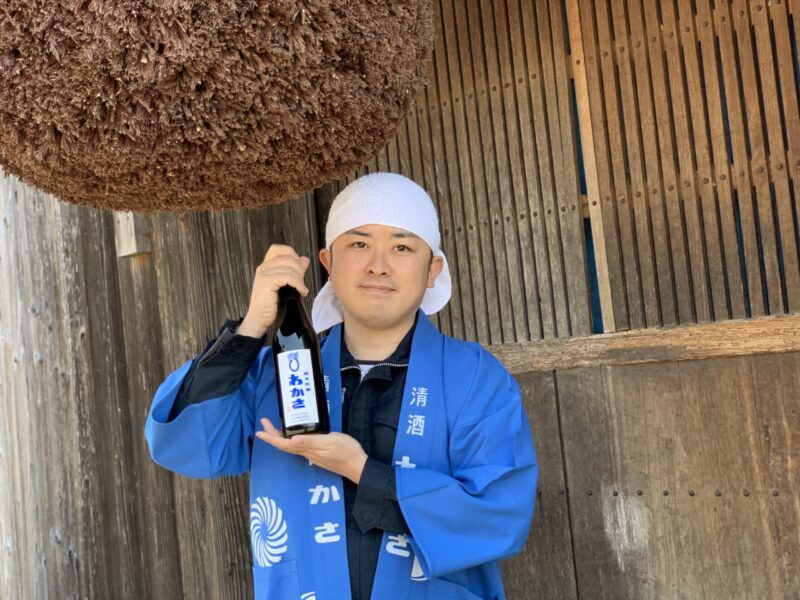 Brewer With Sake Bottle